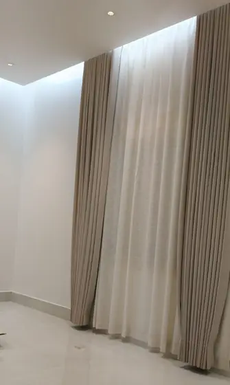 Floor-to-ceiling sheer curtains in a Riyadh majlis
