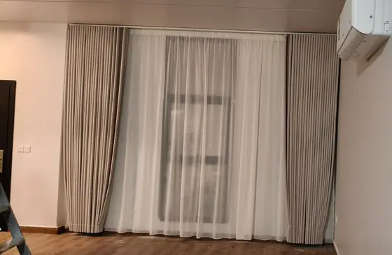 Custom curtains hung across a full living room wall