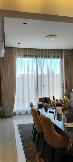 Custom curtains hung across a full living room wall