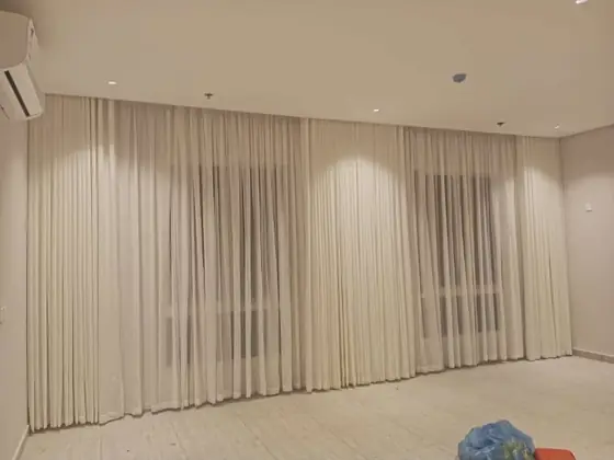 Custom curtains hung across a full living room wall